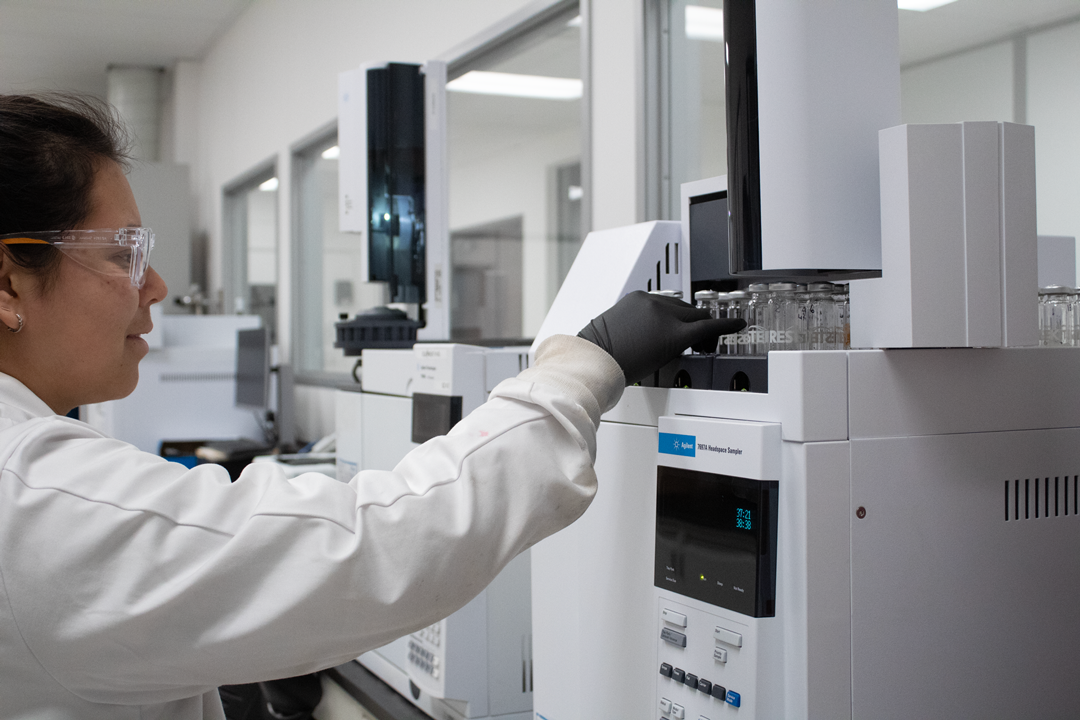 Technician in a testing laboratory working with instrument for dietary supplements testing.