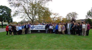 Martin “Marty” Mitchell outside the Certified Laboratories building in Melville, N.Y. with lab employees. 